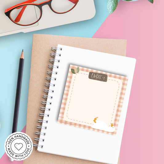 Notepad with checkered border, duck goose illustration, and 'Made with Love' stamp.
