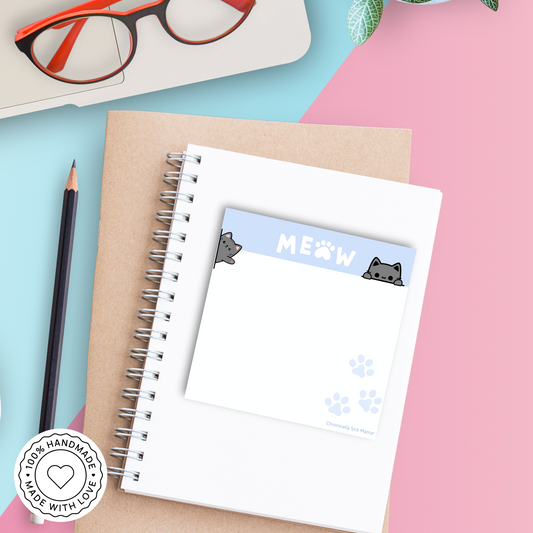 Notebook with cat paw prints on a colorful background