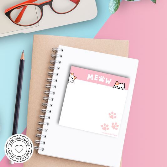 Notebook with cat-themed pages on a colorful background