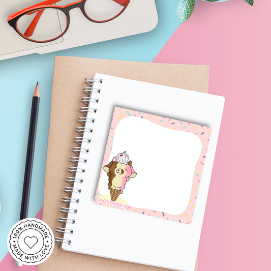 Cartoon cow with ice cream cone on a pink background with sprinkles, branded 'MOOPHORIA'.