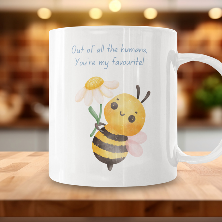 Cute gifts for spoonies, chronic illness warriors or someone special. A mug featuring a bee gifting a flower saying "out of all the humans, you're my favourite!"