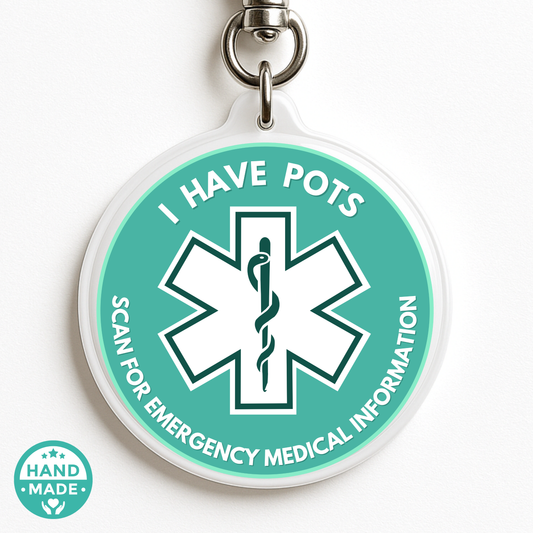 Round green medical alert tag with emergency symbol and text on a white background Pots Medical Alert 