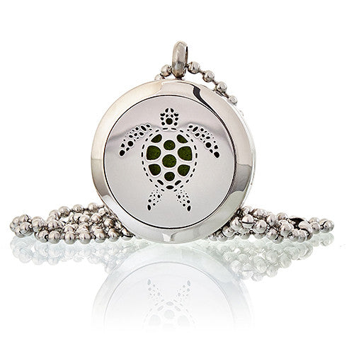 Silver pendant with turtle design on a white background