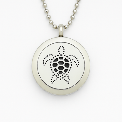 Silver necklace with a round pendant featuring a turtle design on a white background